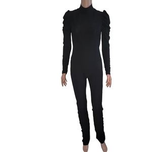 Black pant jumpsuit with rouched sleeves and pant legs.